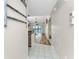 Hallway showcasing the home's layout, leading to the kitchen and living area with scenic views of the lake at 26397 Nadir Rd # 208, Punta Gorda, FL 33983
