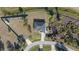 Aerial view of single Gathering home showing a spacious and well-kept lawn with surrounding green space outlined in yellow at 2668 Clovelon St, North Port, FL 34291