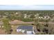 A view of the home surrounded by a lush landscape, showcasing its serene and private setting at 2668 Clovelon St, North Port, FL 34291