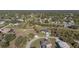 An aerial shot shows a cozy home with a long driveway and well-maintained yard outlined in yellow at 2668 Clovelon St, North Port, FL 34291