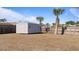 Spacious backyard featuring a shed, palm trees, and privacy fence at 2668 Clovelon St, North Port, FL 34291
