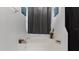 Bathroom showcasing a built-in bathtub with gray curtains and modern fixtures at 2668 Clovelon St, North Port, FL 34291