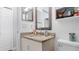 This bathroom has a granite countertop and a unique mirror at 2668 Clovelon St, North Port, FL 34291