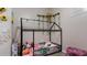 Bright bedroom featuring a house-frame bed with flowers and a play area for creative activities at 2668 Clovelon St, North Port, FL 34291