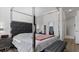 A modern bedroom with a large, upholstered headboard and a neutral color scheme at 2668 Clovelon St, North Port, FL 34291