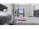 Modern bedroom with a large bed, dresser, television, and window that provides natural lighting at 2668 Clovelon St, North Port, FL 34291