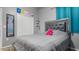 This bedroom has gray walls, white closet doors and a decorative headboard at 2668 Clovelon St, North Port, FL 34291