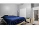 This gray bedroom has a large closet and wood laminate flooring at 2668 Clovelon St, North Port, FL 34291