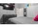The gray bedroom has a TV, dresser, closet and a decorative mirror at 2668 Clovelon St, North Port, FL 34291