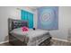 Bedroom features a large bed with storage, blue mandala tapestry, and a modern color scheme at 2668 Clovelon St, North Port, FL 34291