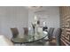 Bright dining space showcasing a glass table with seating, decorative wallpaper, and an open view into the living area at 2668 Clovelon St, North Port, FL 34291
