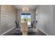 The dining room is decorated with a modern chandelier, patterned wallpaper and comfortable seating for six at 2668 Clovelon St, North Port, FL 34291