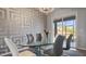 Elegant dining room featuring a glass table, modern chandelier, and decorative accent wall, perfect for sophisticated gatherings at 2668 Clovelon St, North Port, FL 34291