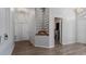 Bright hallway featuring neutral decor, wood-look flooring, decorative niches, and multiple doorways at 2668 Clovelon St, North Port, FL 34291