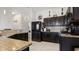 Well-equipped kitchen featuring dark cabinetry, stainless steel appliances, and granite countertops, offering both style and functionality at 2668 Clovelon St, North Port, FL 34291