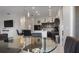 Bright and airy kitchen and living area with a breakfast bar, granite countertops, and pendant lighting at 2668 Clovelon St, North Port, FL 34291