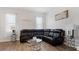 Spacious living room area with a comfortable sectional sofa, stylish decor, and plenty of natural light at 2668 Clovelon St, North Port, FL 34291
