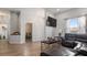 The cozy living room features wood-look floors and a comfortable leather sectional sofa, creating an inviting atmosphere at 2668 Clovelon St, North Port, FL 34291