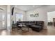 Spacious living room featuring a comfortable leather sectional, modern decor, and wood-look floors at 2668 Clovelon St, North Port, FL 34291