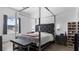 Modern main bedroom with a unique bed frame, stylish decor, and ample natural light from the window at 2668 Clovelon St, North Port, FL 34291