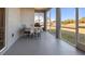 View of a screened porch featuring a table with four chairs and views of the backyard at 2668 Clovelon St, North Port, FL 34291