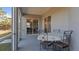 Cozy screened porch area featuring a table, four chairs, and a view into the home at 2668 Clovelon St, North Port, FL 34291