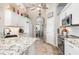 Bright kitchen featuring white cabinets, granite countertops, and stainless steel appliances at 1020 Caliva St, North Port, FL 34286