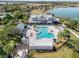 Scenic view of a community pool area with comfortable lounge chairs, umbrellas, and lush landscaping at 16928 Curry Preserve Dr, Punta Gorda, FL 33982