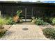 Cozy outdoor patio with paver flooring and garden surrounding the screened-in porch at 18085 Wintergarden Ave, Port Charlotte, FL 33948