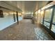 Covered patio with brick flooring, built-in benches and screened windows at 18085 Wintergarden Ave, Port Charlotte, FL 33948