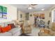 Cozy living room with tile flooring, comfortable seating, and an open view to the kitchen at 1956 Wyoming Ave, Englewood, FL 34224