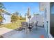 Outdoor patio with seating, umbrella, and a fenced area, perfect for relaxation and outdoor dining at 1956 Wyoming Ave, Englewood, FL 34224