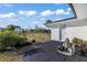 Backyard featuring a brick patio, white exterior, and lush landscaping at 3429 Sleepy Hollow Ln, Punta Gorda, FL 33950