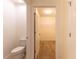 Bathroom showing the toilet and an open door leading to a walk-in closet with shelving at 3924 Candia Ave, North Port, FL 34286