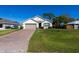 Charming one-story home boasts a manicured lawn and a brick-paved driveway leading to a two-car garage at 3924 Candia Ave, North Port, FL 34286