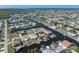 Aerial view of a waterfront home with canal access and a private boat dock, surrounded by lush landscaping at 520 Boardman Dr, Punta Gorda, FL 33950
