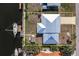 Aerial view showcasing a waterfront property with a metal roof, canal access, and lush landscaping at 520 Boardman Dr, Punta Gorda, FL 33950