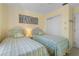 Bedroom with two twin beds, white wicker headboards and 'Beach House' decor at 520 Boardman Dr, Punta Gorda, FL 33950