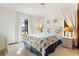 Bright bedroom featuring a seashell-themed bed set, white wicker furniture, and natural light at 520 Boardman Dr, Punta Gorda, FL 33950