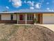 Charming single-story home with a red front door, well-maintained landscaping, and a clean, attractive facade at 520 Boardman Dr, Punta Gorda, FL 33950