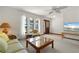 Inviting living room with large windows, neutral carpet, and cozy furnishings, perfect for relaxation at 520 Boardman Dr, Punta Gorda, FL 33950