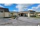 Charming exterior view of building with covered entryway, and well-maintained landscaping on a sunny day at 6671 Keystone Ct, North Port, FL 34287