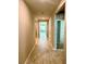 Inviting hallway with neutral paint, tile flooring, and views into the living spaces with natural light at 9525 Turtle Grass Cir, Punta Gorda, FL 33950