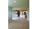 Open-concept kitchen features white cabinets and modern appliances, seamlessly connected to the living space at 9525 Turtle Grass Cir, Punta Gorda, FL 33950