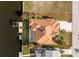 Aerial view of a property with private pool, dock, and landscaped yard on a waterfront lot at 126 Peckham Sw St, Port Charlotte, FL 33952
