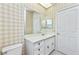 Bathroom featuring vanity with decorative pulls, large mirror, and toilet at 126 Peckham Sw St, Port Charlotte, FL 33952