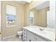Stylish bathroom featuring decorative wallpaper, vanity, and window at 126 Peckham Sw St, Port Charlotte, FL 33952