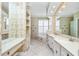 Primary bathroom featuring dual sink vanities, a soaking tub, and plenty of cabinet space at 126 Peckham Sw St, Port Charlotte, FL 33952