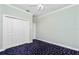 Bedroom with ceiling fan, closet, and blue patterned carpet at 126 Peckham Sw St, Port Charlotte, FL 33952