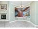 Light-filled dining area with large windows overlooking the pool, a decorative chandelier, and fireplace at 126 Peckham Sw St, Port Charlotte, FL 33952